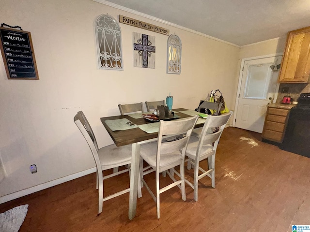 dining room with baseboards and crown molding