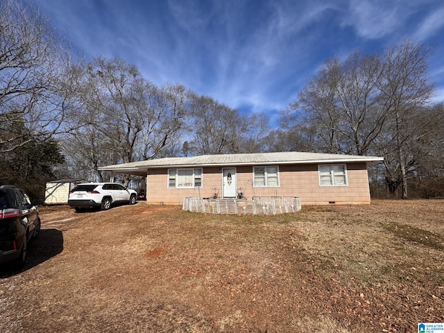 single story home with crawl space, driveway, metal roof, and a carport