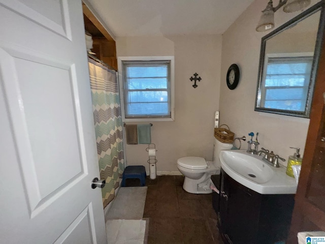 bathroom featuring tile patterned flooring, curtained shower, vanity, and toilet