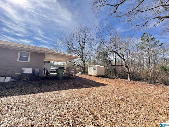 view of yard with a storage unit, an outdoor structure, and an attached carport