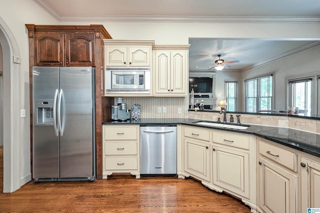 kitchen featuring dark hardwood / wood-style flooring, sink, cream cabinetry, and appliances with stainless steel finishes