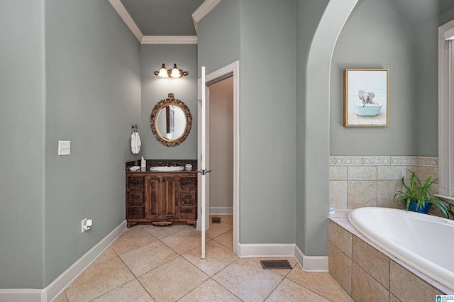 bathroom featuring crown molding, vanity, tile patterned flooring, and tiled tub