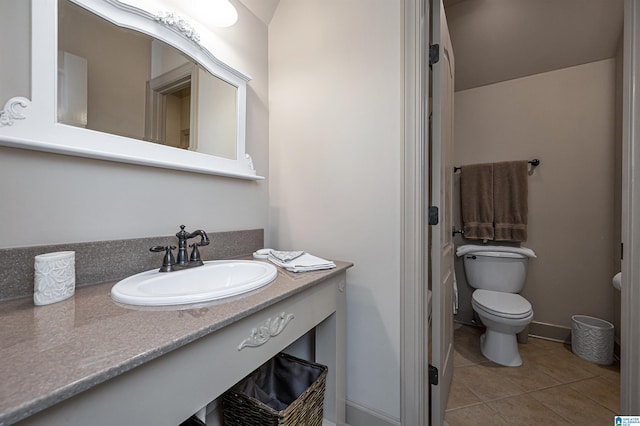 bathroom featuring vanity, tile patterned floors, and toilet