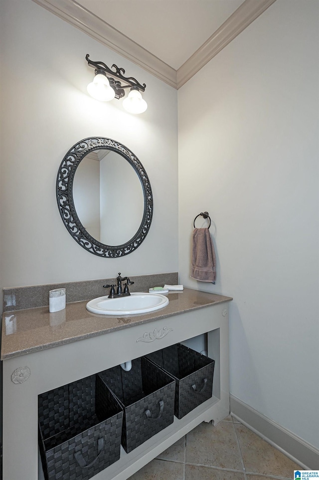 bathroom featuring tile patterned flooring, ornamental molding, and sink