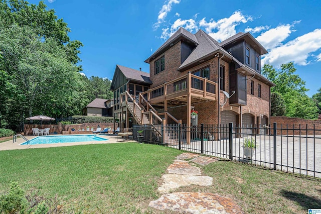 exterior space with a wooden deck, a lawn, and a patio area