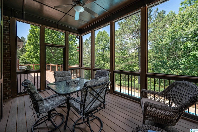 unfurnished sunroom with ceiling fan