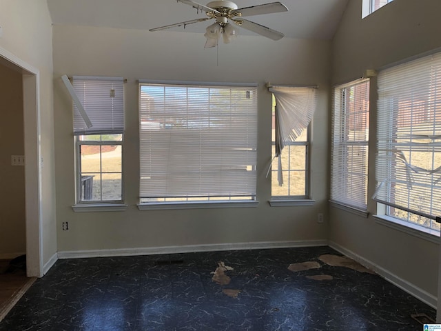 empty room featuring ceiling fan and vaulted ceiling