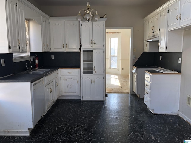 kitchen with sink, an inviting chandelier, tasteful backsplash, dishwasher, and white cabinets