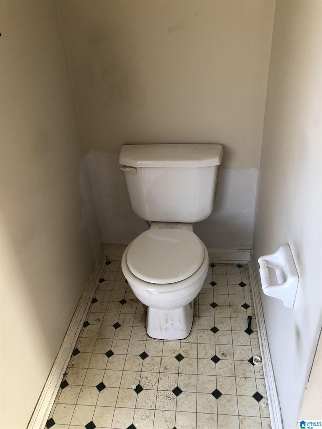 bathroom featuring toilet and tile patterned flooring