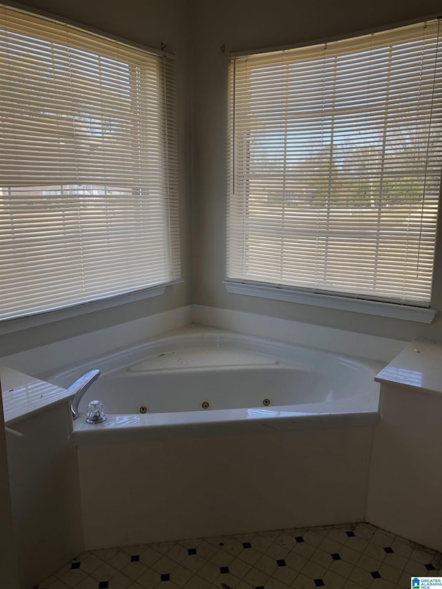 bathroom featuring a bath, a wealth of natural light, and tile patterned floors