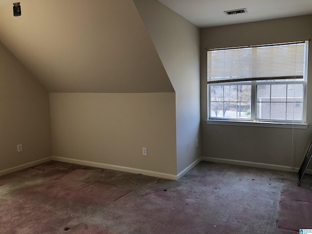 bonus room featuring lofted ceiling and carpet flooring