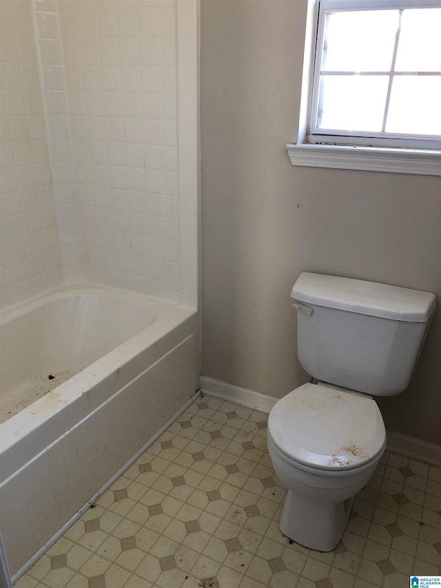 bathroom featuring toilet and a bathing tub