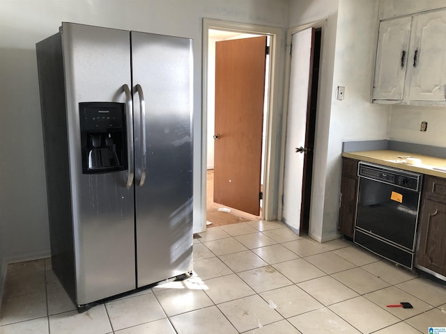 kitchen featuring stainless steel refrigerator with ice dispenser, black dishwasher, light tile patterned flooring, and dark brown cabinets