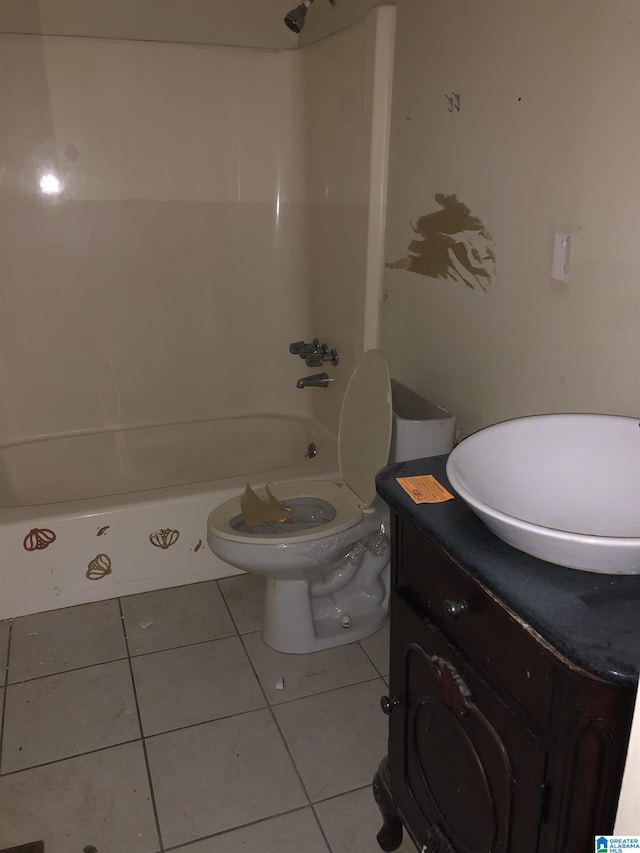 bathroom with tile patterned flooring, vanity, and toilet