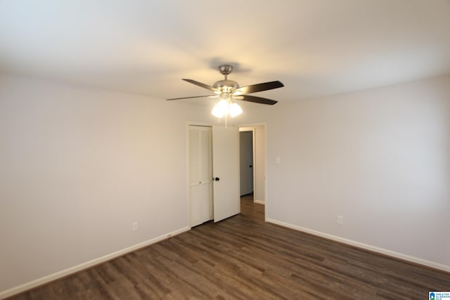 empty room featuring dark hardwood / wood-style floors and ceiling fan