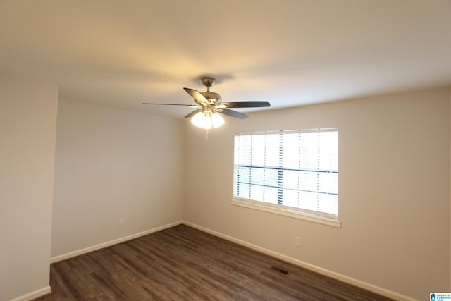 spare room featuring ceiling fan and dark hardwood / wood-style flooring