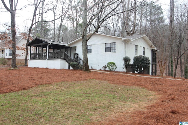 view of side of property with a lawn