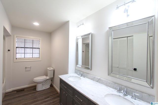 bathroom with vanity, hardwood / wood-style floors, and toilet