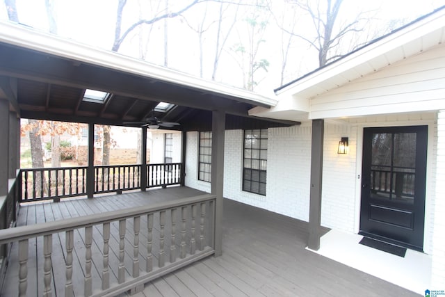 wooden terrace with ceiling fan and covered porch