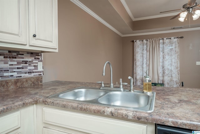 kitchen with visible vents, a sink, dishwasher, crown molding, and tasteful backsplash