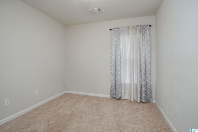 carpeted empty room with baseboards and visible vents