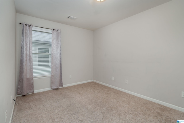 unfurnished room featuring visible vents, baseboards, and carpet flooring