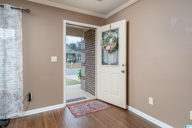 foyer entrance featuring baseboards, wood finished floors, and ornamental molding