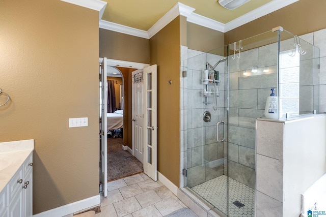 bathroom featuring tile patterned floors, crown molding, a shower with shower door, and vanity