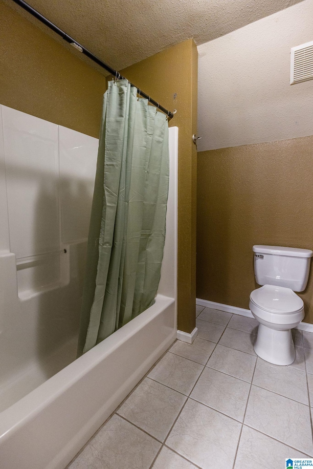 bathroom featuring tile patterned floors, toilet, shower / bath combo, and a textured ceiling