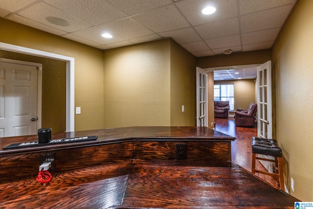 home office featuring hardwood / wood-style floors and a paneled ceiling