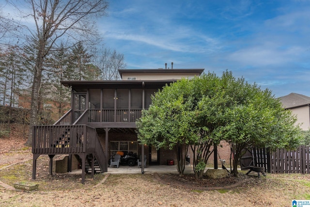 rear view of house with a patio and a sunroom