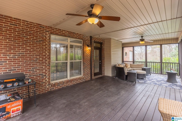 unfurnished sunroom with ceiling fan