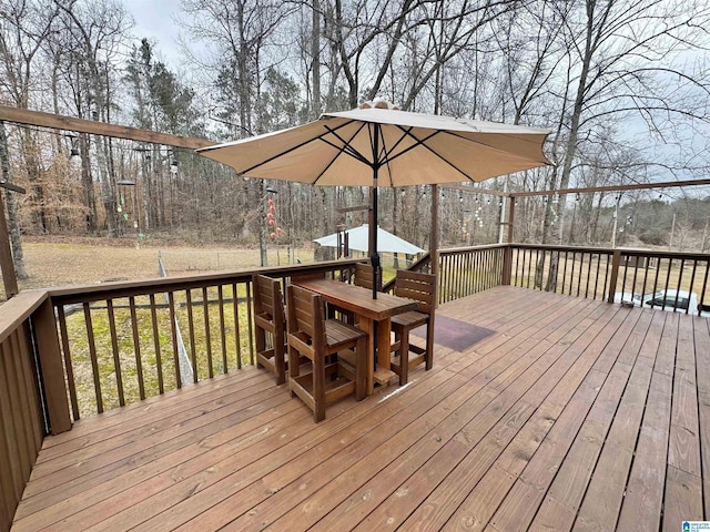 wooden terrace featuring a lawn