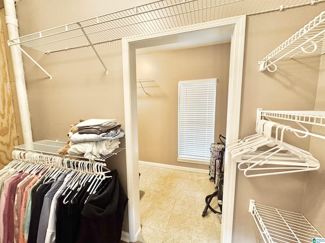 spacious closet featuring light tile patterned floors