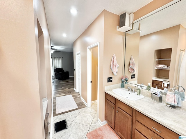 bathroom featuring ceiling fan, vanity, and tile patterned flooring