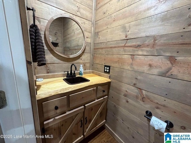 bathroom with vanity and wooden walls