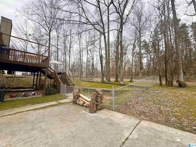 view of yard with a wooden deck and central AC unit