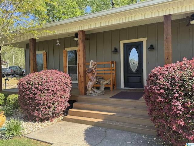 view of exterior entry featuring board and batten siding and a porch