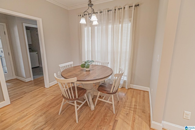 dining area with ornamental molding, a healthy amount of sunlight, an inviting chandelier, and light wood-type flooring