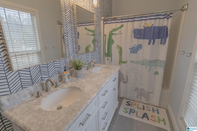 bathroom featuring tile patterned flooring, vanity, and shower / bath combo with shower curtain