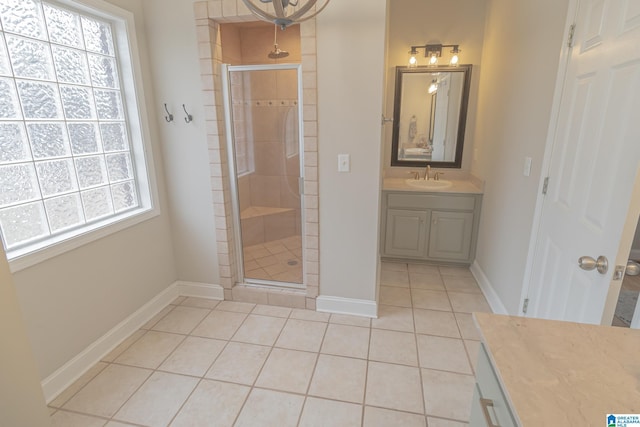 bathroom featuring tile patterned flooring, vanity, and walk in shower