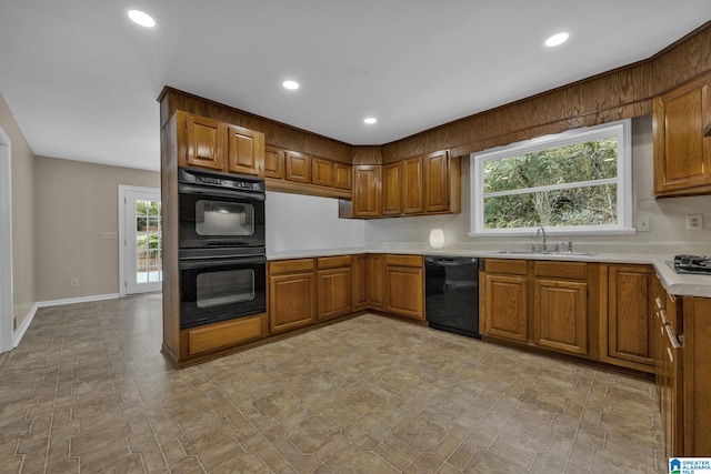 kitchen featuring a healthy amount of sunlight, sink, and black appliances