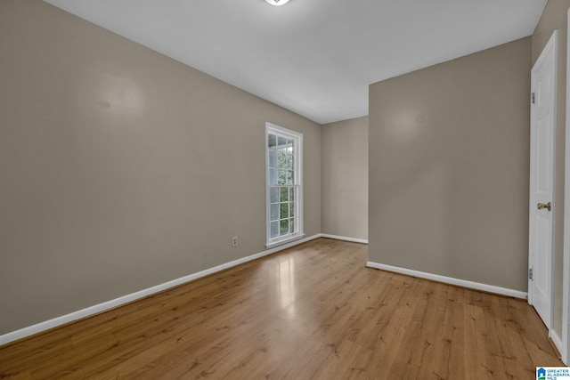 empty room with light hardwood / wood-style flooring