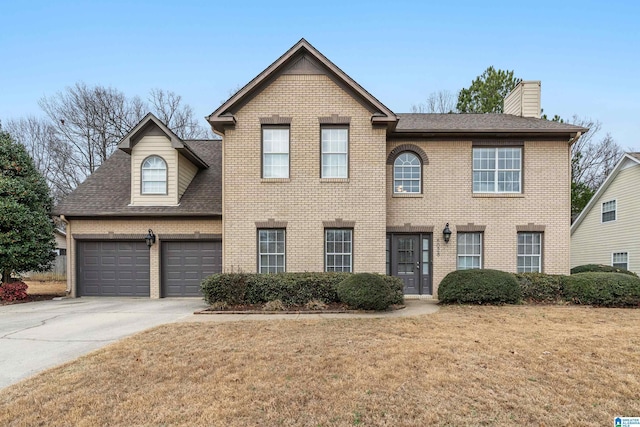 view of front of home featuring a garage and a front yard