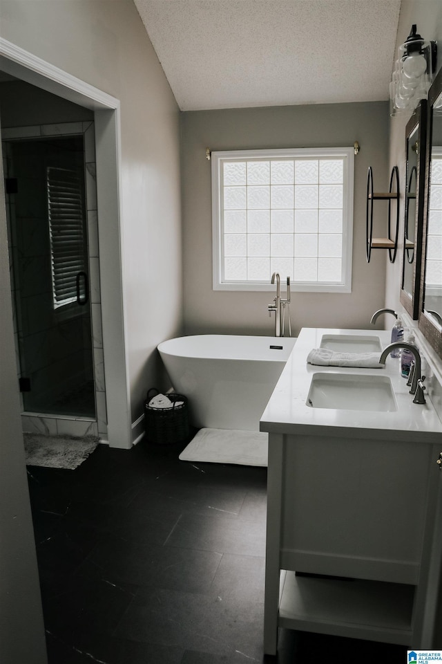 bathroom with independent shower and bath, vanity, and a textured ceiling