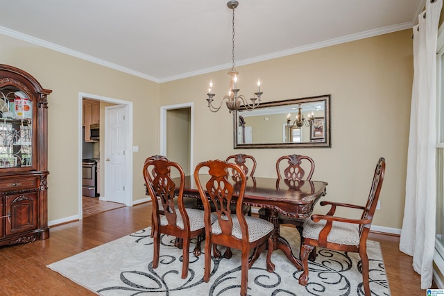 dining area with hardwood / wood-style flooring and ornamental molding