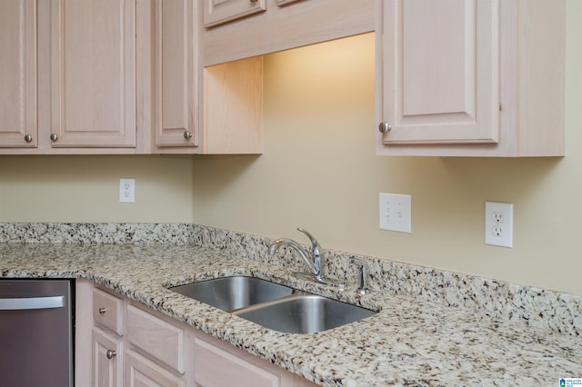 kitchen featuring sink, light brown cabinets, stainless steel dishwasher, and light stone countertops