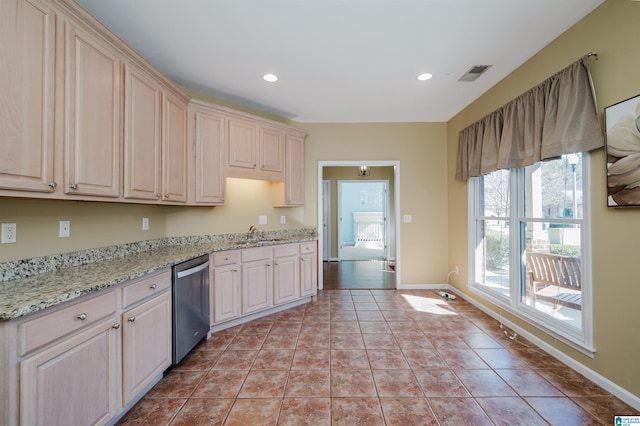 kitchen with dishwasher, sink, light stone countertops, and light tile patterned floors