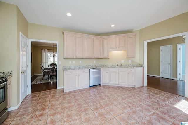 kitchen featuring light stone countertops, light tile patterned floors, stainless steel appliances, and sink