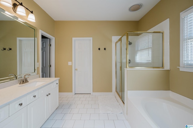 bathroom featuring tile patterned floors, vanity, and shower with separate bathtub